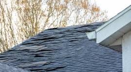 storm damaged roof with tarp